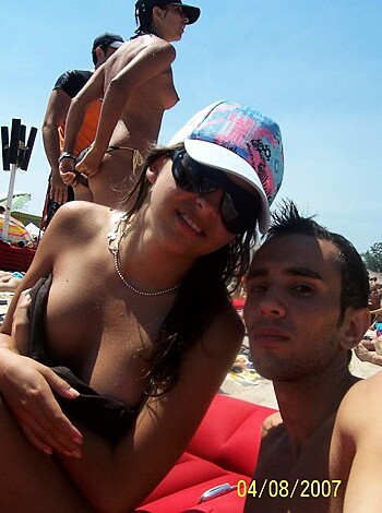 A fuckin' horny dickhead dude takin' pics with two titties babes by the sea.
