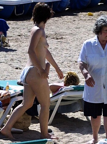 "This fucking image shows a hot chick strolling down the shore with her tits bouncing around in the wind, not giving a shit about any prude eyes judging her."