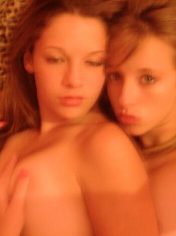 "This image depicts two scantily-clad chicks banging lips while grinding their pussies together."