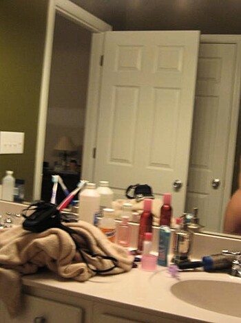A scantily clad babe takes a shameless ass shot, revealing her flawless rump while checking out her reflection in the mirror.