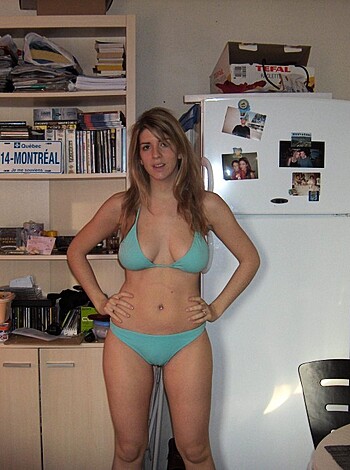Here's a limp dick description of a hot chick in a skimpy bathing suit, with her tits out and her ass on full display.