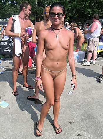 Here's a hot, young chick with her panties off, showing off her snatch in the sunshine, while she grins for the camera like a fucking idiot at some bullshit festival.