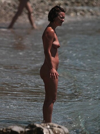 "This image shows a f*cking hot chick with her pussy barely covered by the water, standing in the goddamn ocean."