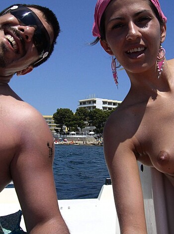 Here's the vulgar description of the image: "Two naked boob-lovin' dummies on a yacht, f*ckin' and suckin', chillin' like big dogs."