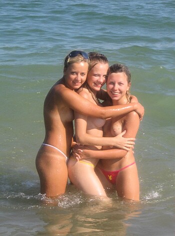 Three fucking hot nude bitches making out on the sandy shoreline, tits out for all to see.