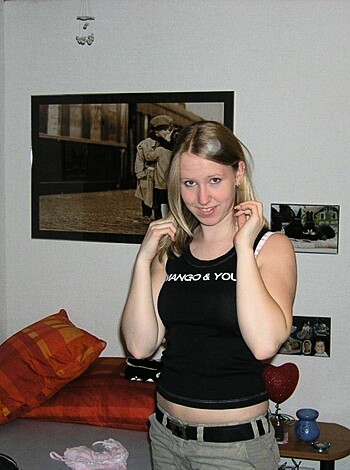 "Busty broad showin' off her tits in a black lacy bra."