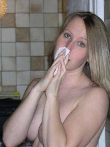 This image depicts a fucking nude chick blowin' her goddamn nose with a fucking tissue.