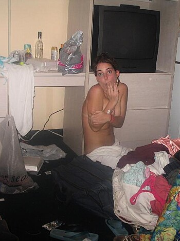 A naked bitch is standin' among a fucking messy apartment.