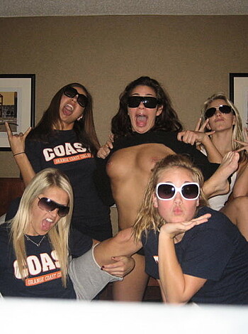Vulgar description:
Look at these fuckin' dumb bitches posing for a goddamn picture like they're fucking party animals. One fat-titted cunt ain't even wearing no shirt, showing off her tits like she gives a fuck.