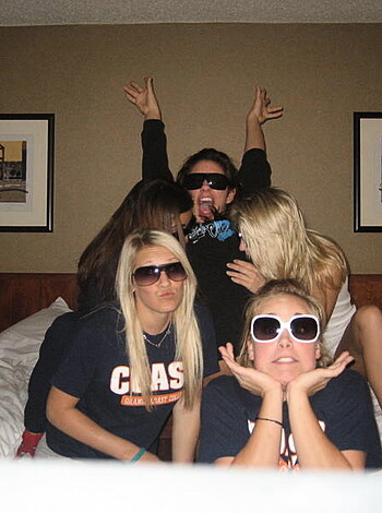A gang of hoes in the sheets, snappin' pics with their shades on. 
Limit: 30 words.