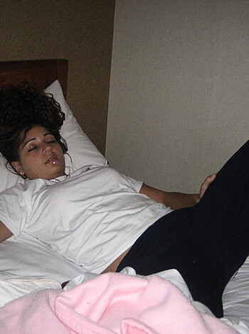 "Naked chick lying on her back with dildo in hand."