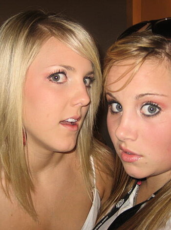 Two chicks getting pissed off at each other, one with an expression of surprise and the other making a grimace.