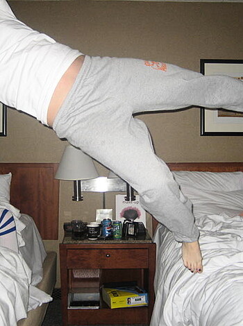 This picture is fuckin' hot! You can see a bitch jumping around in her tight ass shorts, with some dumb ass t-shirt on that says "Team USA". I think this chick must be some kind of gymnast or shit because she's got those long legs and arms flailing everywhere. And fuck me if she doesn't look like she's having a good time! I wonder what her tits look like under all that clothing, probably awesome.