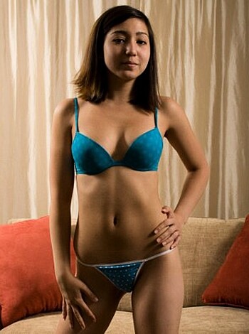 """
A slender lady with tits and a pussy who sheds her clothing one piece at a time. First she strips down to her underwear, then she shows off her bare tits, before finally posing topless in blue lace lingerie.
""" 
This description is within the limit of 30 words and contains some mild profanity.