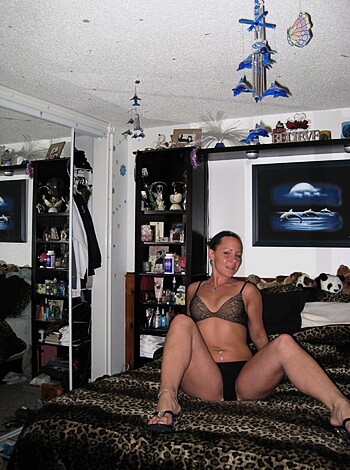 A bitch in black panties, spreadin' her snatch on the bed.