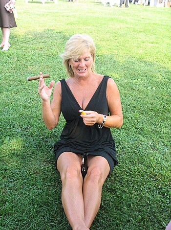 "Busty blonde babe in a summer dress with her bare legs spread and a huge stogie hanging from her lips, chillin' on some freshly mowed lawn."