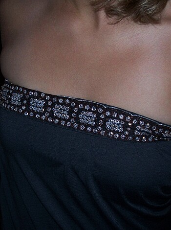 This image shows the woman's left tits hanging out.
