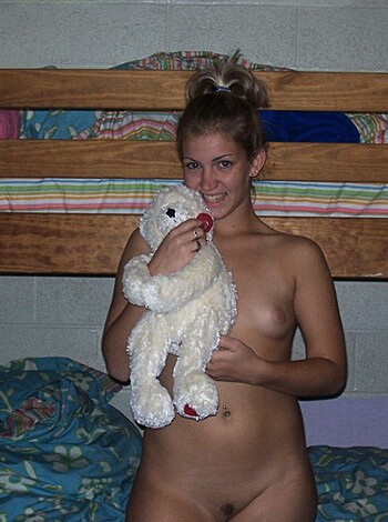 Look at this fucking picture of some hot chick with tits hanging out, lying on a goddamn bed with a giant-ass teddy bear in her arms. This is pure fucking art, man.