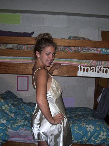 The photo features a busty honey in a metallic outfit with her teeth bared, looking like she's ready to fucking party.