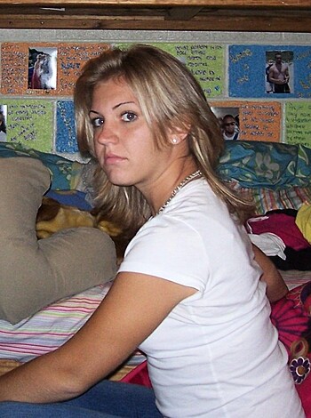 Vulgar description: "Here's a hot ass chick with no shirt on, sittin' on a damn bed."