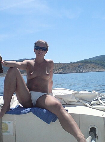 Here's the fucking image of some dickhead with no clothes on, standing on a goddamn boat like he owns the fucking place.