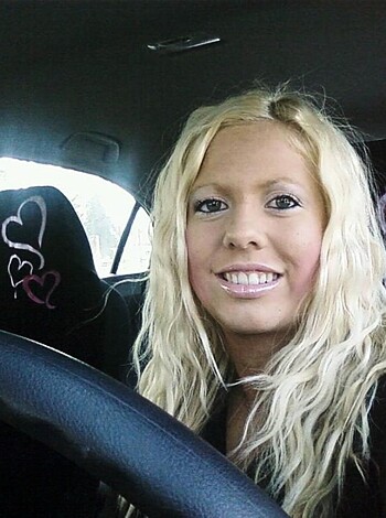 Here's a photo of some hot chick driving a car, looking all sexy and shit while she dabs on some makeup.

Or

Check out this fucking picture of some slutty bitch getting her hair done while she's behind the wheel, looking like a total whore.