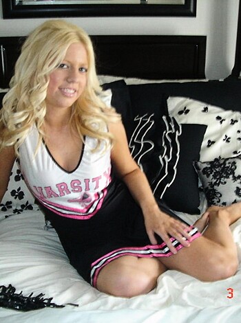 Babe in bobby socks and pompoms taking it up the ass, as she's laid out flat-backed on her futon with her tits hanging out of her low cut tank top, and you can see a hint of her shaved bush through that slit in her shorts.
