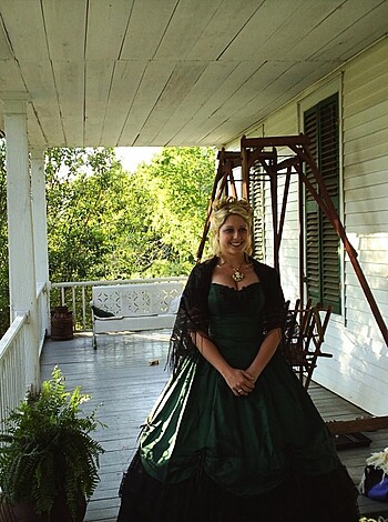 This bitch is rockin' a frilly, fuck-me dress while some dude suits up in a dandy-ass suit as they both lounge on some Victorian front porch, giving the camera a cheesy smile and all sorts of prim 'n proper posing.