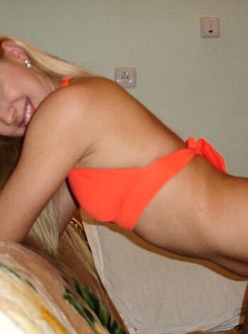 The blonde bitch is wearing a fucking tight red bikini that accentuates her big tits and tiny waist.