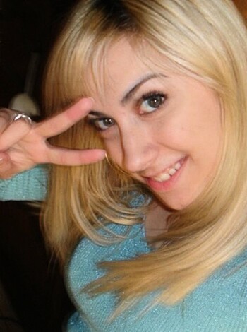 "This is an image of some smiley cunt covering her mouth with her hand."
