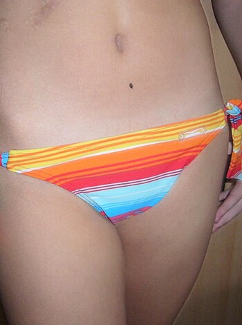 The chick's navel pokes out of her bikini bottoms.