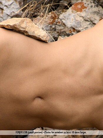 "Take a good look at this picture of some bitch with her tits out and a rock between them, smiling like she's fucking horny or something."