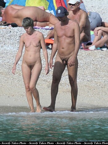 Here's a f**king image of a nude couple strolling down a sandsheet.