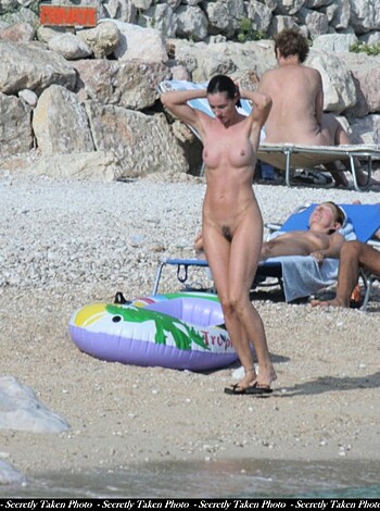 """
A completely fucking nude bitch strutting her ass on the sandy shore, surrounded by some perverts. 
"""
