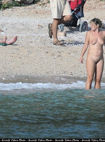 "Hot bitch struts her tits and pussy onto sandy shore, then slinks into sea."