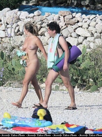 "A hot bitch struts her naked ass down the shore, carrying an impractically small towel."