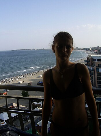 "A hot blonde in a skimpy two-piece gives the camera a come hither glance."