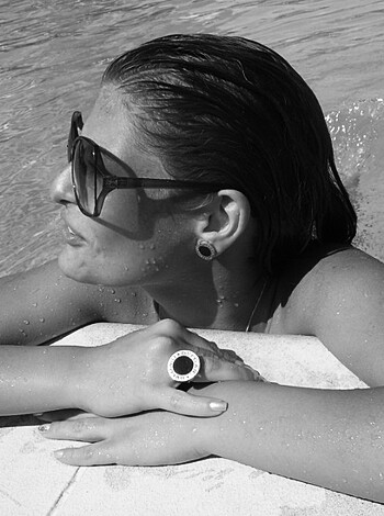 A bitch in shades is chillin' ass-up in the fucking pool, gettin' her swim on.