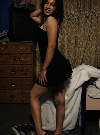 A hot chick in a slinky black number is giving us a peep-show by crossing one leg over the other, flashing her thong and getting all up in our grill with her sexy stance.