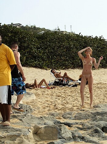 The hell yeah! Shots galore of this titted blonde strutting her stuff at the seashore, with throngs of horny dudes ogling her.