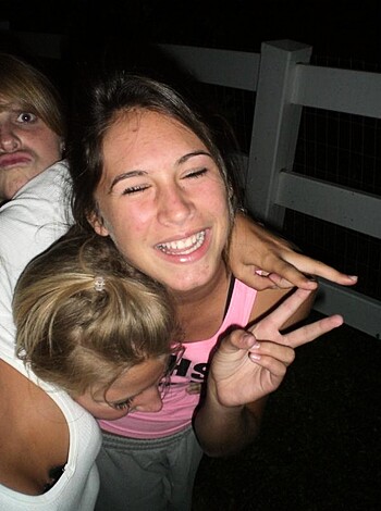 A bunch of sluts out drinking, taking pics for Instagram. Bitches posing and shit, one holding up the peace sign. One has her tits out laughing like a retarded cunt.
