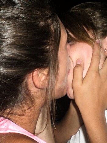 This picture depicts two chicks smoochin' with tongues and everything while their fingers playfully roam each other's bodies, leaving the viewer with a raging hard-on that won't quit.