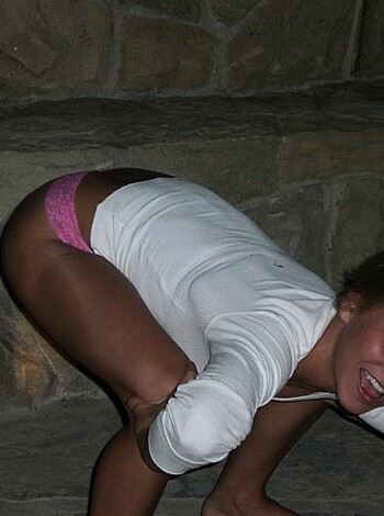 "This photo features a hot chick with a juicy booty, showing off her tight ass crack in a white jacket and pink underwear."