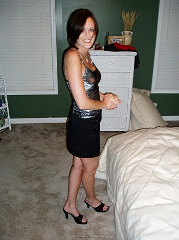 Vulgar description of image: "Check out this bitch in her high heels, fucking the sheets on that fancy-ass bed, looking all sexy with her skirt hiked up and shit."
