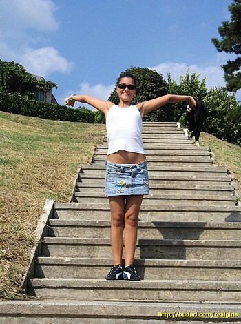 "Fucking hot babe taking selfie in mini skirt on stairs, showing off tits."