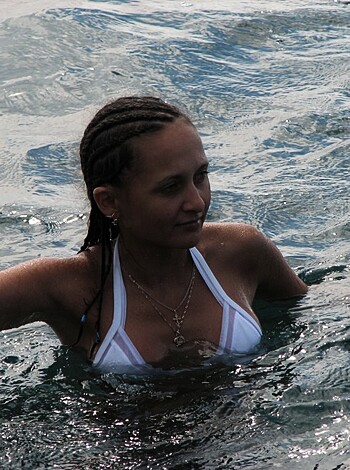 A smoking-hot babe is posing for a sexy beach pic in her barely-there bikini, frolicking in the salty waves.