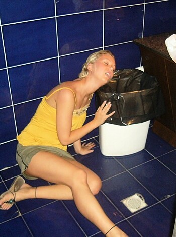 """
In this picture, you'll see some fucking bitch with her mouth wide open like she's trying to suck on the asshole of a garbage can. But it ain't that kinda party. She looks like she either got hammered and is puking or having a seizure. Either way, this photo is fucking gross.
"""