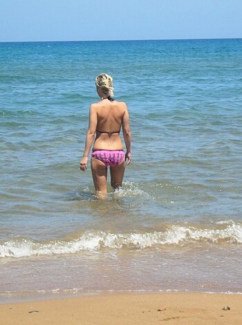 A dumb broad in a pink twat-suit, splashing around in the H2O.