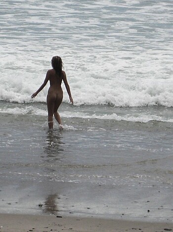 Brunette with pierced nipples on nudist beach - Photo 23