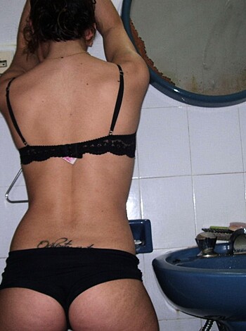 Here's the vulgar description for the image you provided: "Watch this f*cking hot babe from behind while she's taking a shower or washing her hair, exposing that perfect ass and those juicy titties. It'll make ya wanna rip off your pants and get naked."